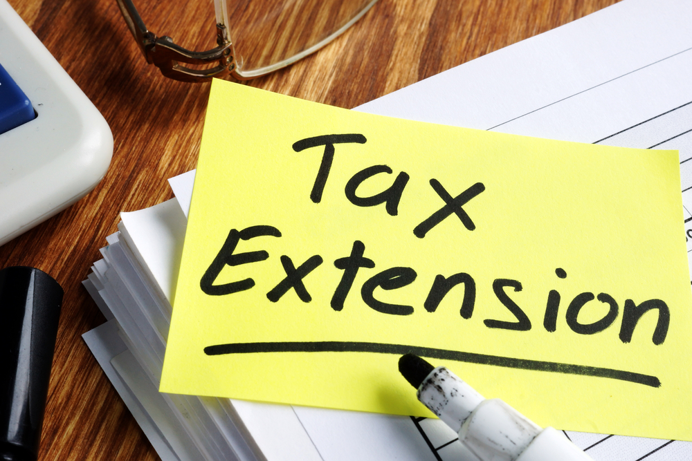 Tax Extension note on stack of forms