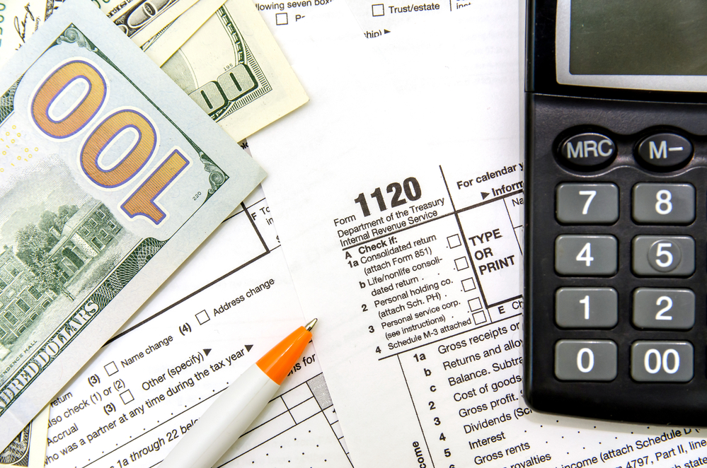 Tax forms, money, and calculator