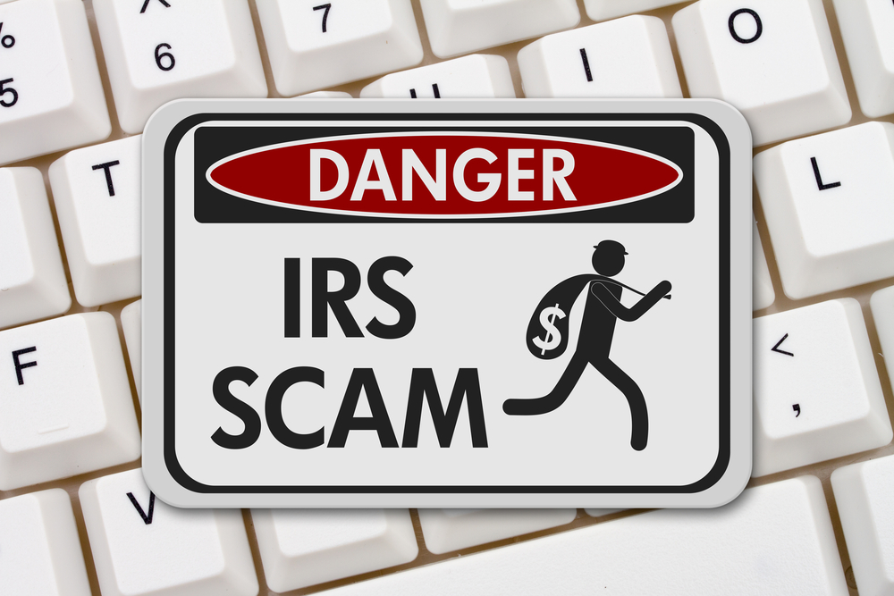 Danger IRS Scam sign on keyboard
